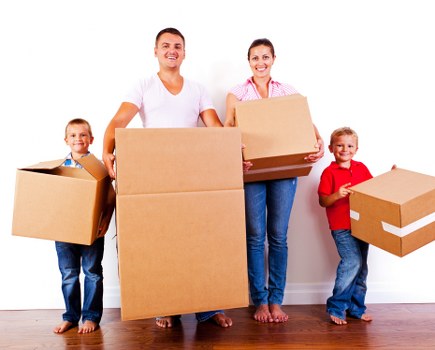 Boxes and furniture being loaded into a moving van