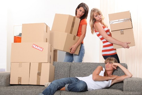 Professional movers carrying furniture into a Wandsworth property