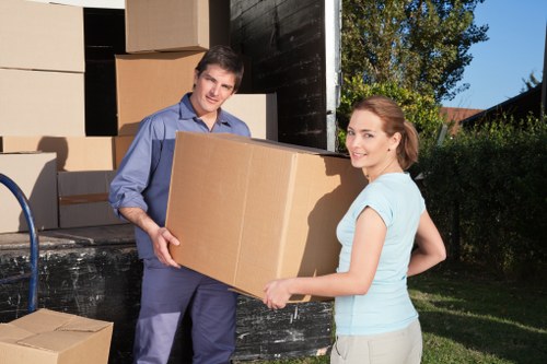 Packed boxes and furniture being carried through a Wandsworth residential street